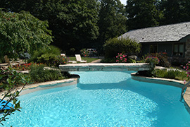 Stone bridge over swimming pool.